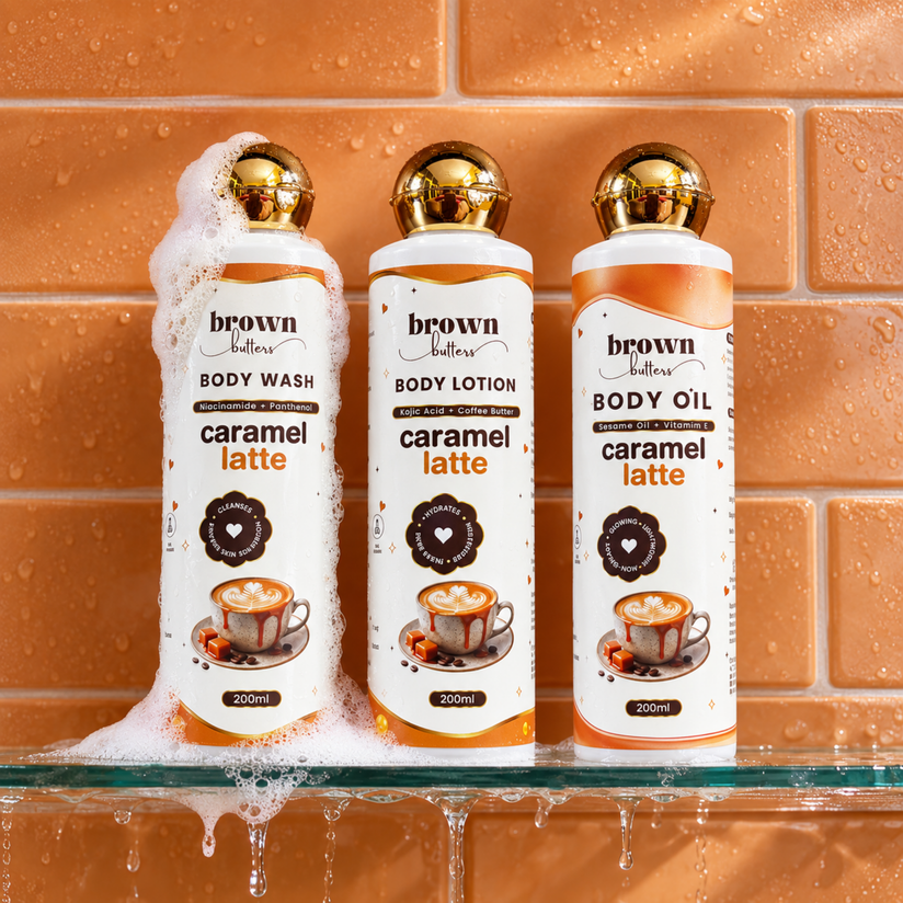 Brown Butters Caramel Latte Body Wash, Lotion and Oil bottles on a wet orange tiled shelf