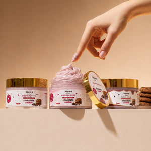 Brown Butters Chocolate Cookie Dessert Spa Trio on beige, a hand touching the pink whipped soap jar.