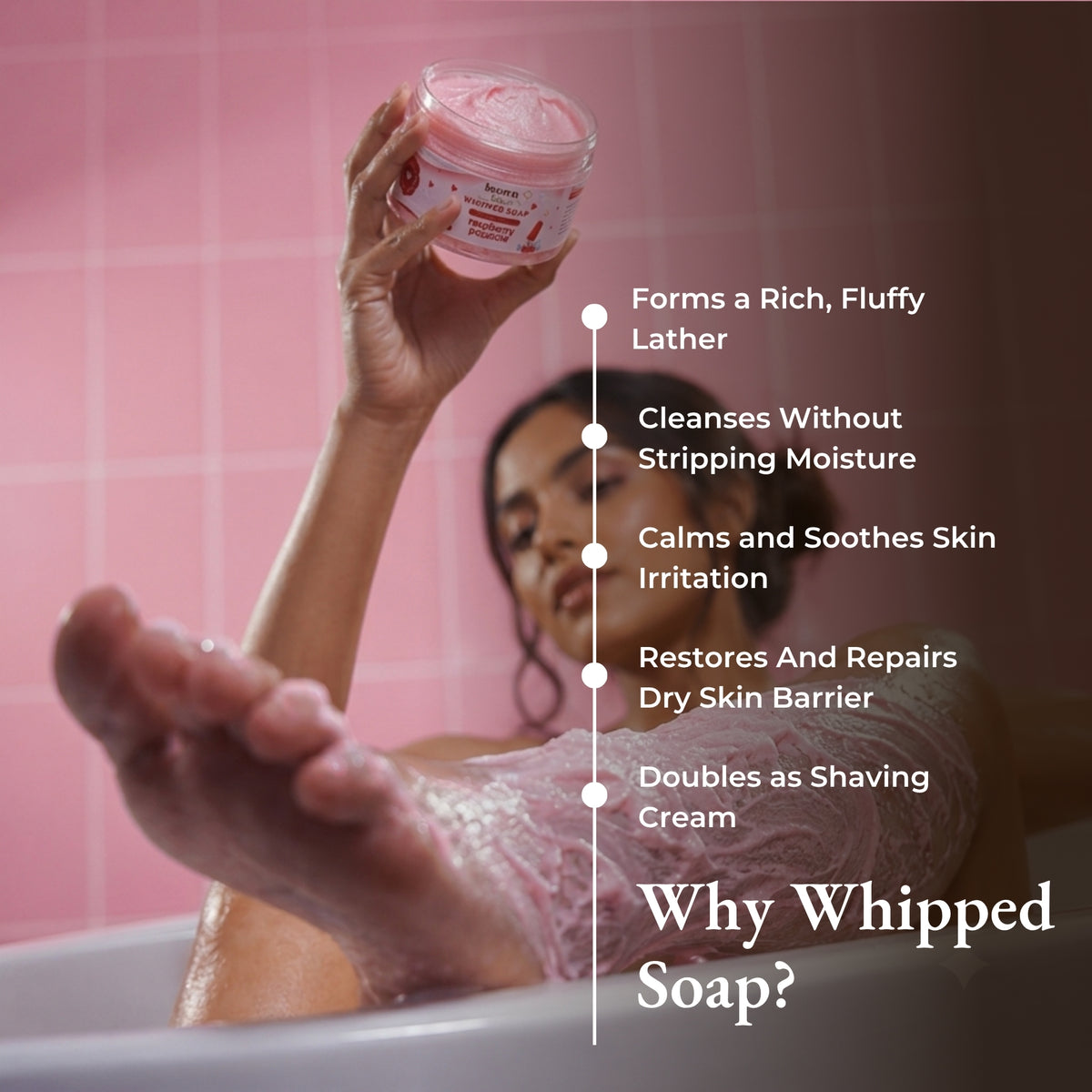 Brown Butters Raspberry Popsicle whipped soap held in a pink tiled bath, with lather and shaving benefits.