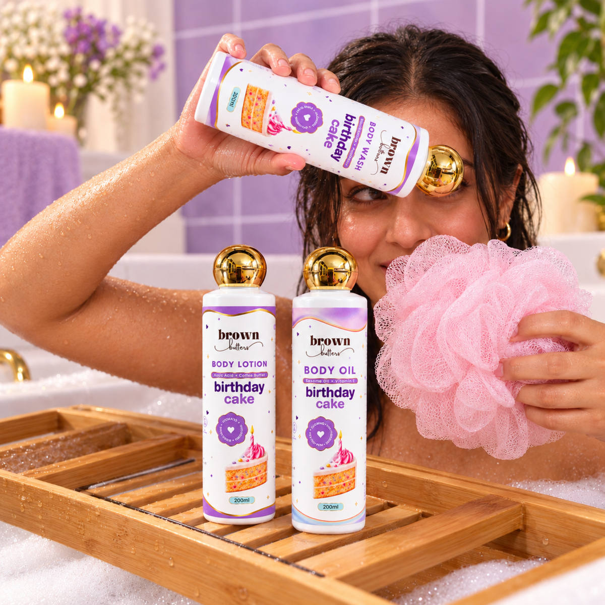 Brown Butters Birthday Cake Trio lifestyle shot in the bathtub with wash, lotion and oil bottles
